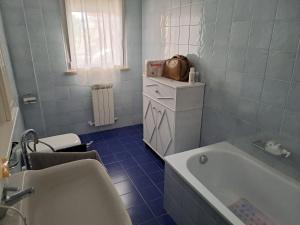 a white bathroom with a tub and a sink at Serenità in centro città in Senigallia +14 photos