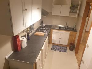 a kitchen with white cabinets and a counter top at Serenità in centro città in Senigallia