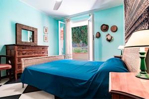 a blue bedroom with a bed and a window at Appartamento Vista Mare - Spriano in Rio Marina +47 photos