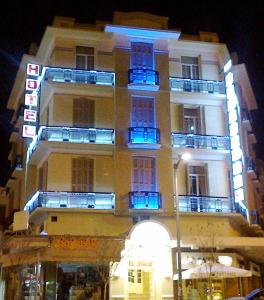 a building with blue balconies on the side of it at Metropolis Hotel in Serres