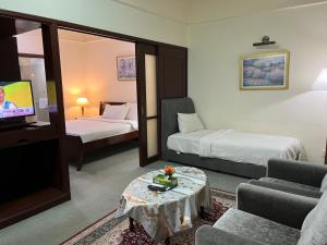 a hotel room with two beds and a tv at Millennium Suites At Berjaya Times Square KL in Kuala Lumpur