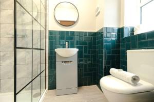 a bathroom with a toilet and a sink and a mirror at The Willow - Studio 27 in Bristol