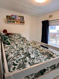 a bed with a black and white comforter in a bedroom at The Rustic Retreat in Heerlen +11 photos