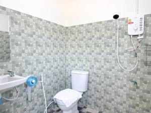 a bathroom with a shower and a toilet and a sink at Jira Hotel in Lampang +26 photos