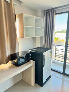 a microwave on a counter in a room with a window at หลังมอรีสอร์ท in Ban Hua Khwai +55 photos