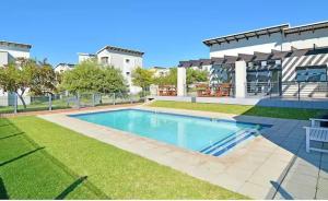 a large swimming pool in front of a building at Tranquility facing Steyn City in Sandton