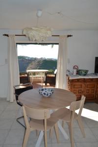 a table and chairs in a kitchen with a view at Finca Diego García - studio vue mer in Vélez-Málaga
