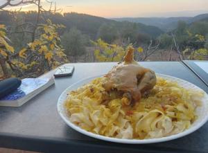 a plate of food with a chicken on top of pasta at Gîte tazekka in Taza