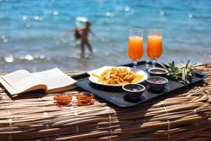 a table with a plate of food and two glasses of orange juice at Niche Söğüt in Marmaris
