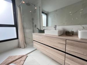 a bathroom with two sinks and a large mirror at Benidorm Beach apartment - Costa Blanca in Benidorm