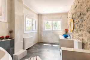 a bathroom with a stone wall and a sink at Serenity Retreat in Pidasos in Pídhasos +45 photos