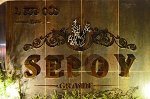 a sign for a store on the side of a building at Sepoy Grande Mysore in Mysore