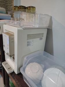a white sewing machine sitting on top of a table at Jack's house Thara in Krabi