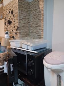a bathroom with a toilet and a sink at Jack's house Thara in Krabi