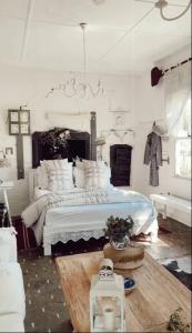 a bedroom with a large white bed in a room at The Old Bakery in Historic Kangaroo Valley Village in Kangaroo Valley