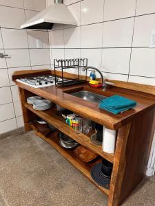 a kitchen counter with a sink and a stove at Lo de Capretta 2 in Almafuerte