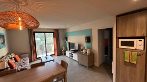 a living room with a couch and a table at Trestraou 217 in Perros-Guirec