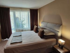a bedroom with a large bed with a large window at The White House Guest House in Nesebar +102 photos