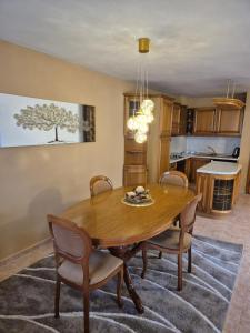 a kitchen and dining room with a wooden table and chairs at The White House Guest House in Nesebar