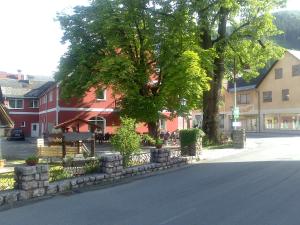 a street in a town with a tree and buildings at Gasthof Post in Sankt Gallen