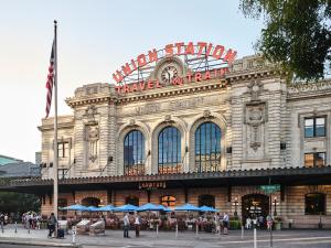 a large building with a sign on top of it at The Crawford Hotel in Denver