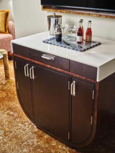 a counter with wine bottles and glasses on it at The Crawford Hotel in Denver
