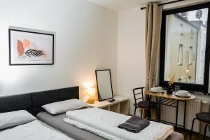 a bedroom with a bed and a desk with a mirror at Cozy and central Apartment Lübeck in Lübeck