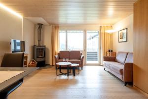 a living room with a couch and a table at Apartment Bischofberger D20 in Amden