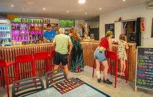 a group of people standing at a bar at ZEcamping chiens acceptés espace aquatique et bar in La Baule