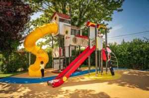 a playground with a slide in a park at ZEcamping familial dog friendly familial parc aquatique in Olonne-sur-Mer