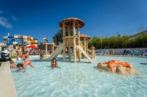 a group of people in the water at a water park at ZEcamping familial avec parc aquatique - chiens acceptés in Saint-Jean-dʼOrbetiers