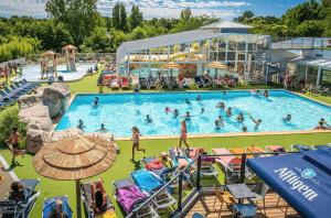 a group of people in a pool at a resort at ZEcamping familial avec parc aquatique - chiens acceptés in Saint-Jean-dʼOrbetiers +6 photos
