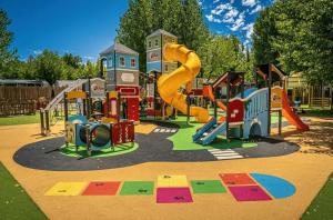 a playground with a slide in a park at ZEcamping familial avec parc aquatique - chiens acceptés in Saint-Jean-dʼOrbetiers