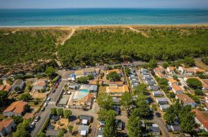 an aerial view of a parking lot next to the beach at ZEcamping animé piscine couverte club enfant animations dog friendly in La Faute-sur-Mer