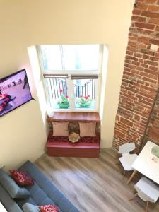 a living room with a blue couch and a window at Center Lviv Avenue 23 in Lviv +14 photos