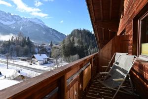 a chair on a balcony with a view of the mountains at Marienberg in Biberwier +17 photos