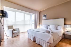 Postel nebo postele na pokoji v ubytování Hotel Nagusi