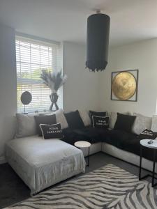 a living room with a black couch and a rug at Chesil Beach View in Fortuneswell +11 photos
