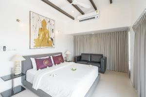 a bedroom with a large bed and a chair at 3 Bedroom Luxury 5 Star Seaview Villa Esprit SDV087-By Samui Dream Villas in Bang Rak Beach +25 photos