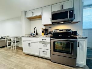 a kitchen with a stove and a microwave at Fountain Haven in Indianapolis