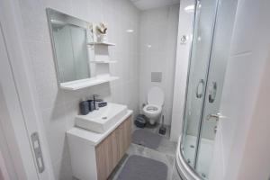 a white bathroom with a sink and a toilet at Classic Suite TS32 in Esenyurt