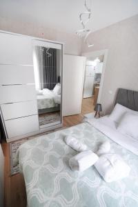 a bedroom with a large bed with pillows and a mirror at Classic Suite TS32 in Esenyurt