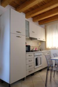 a white refrigerator in a kitchen with a table at Adria Art Apartments 2 in Adria