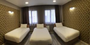 Postel nebo postele na pokoji v ubytování Okur Otel