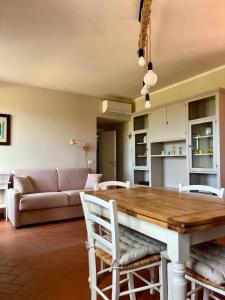 a living room with a table and a couch at Eri tra gli Ulivi in Gropina