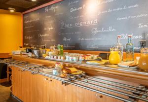 a restaurant counter with a chalkboard with food on it at B&B HOTEL Marseille Bonneveine in Marseille +30 photos