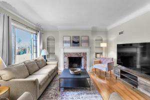 a living room with a couch and a fireplace at Spacious Omaha Retreat in Omaha
