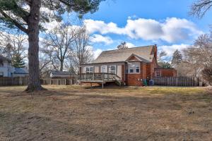 a brick house with a porch and a tree at Spacious Omaha Retreat in Omaha