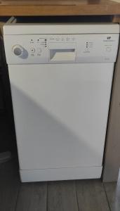 a white dishwasher sitting under a kitchen counter at Gîte tout confort entièrement équipé 50 m2 autonome, avec parking in Saint-Sixte +4 photos
