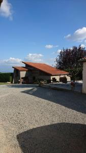 a large building with a red roof on a street at Gîte tout confort entièrement équipé 50 m2 autonome, avec parking in Saint-Sixte